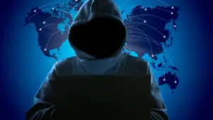Person in a hoodie in front of a world map
